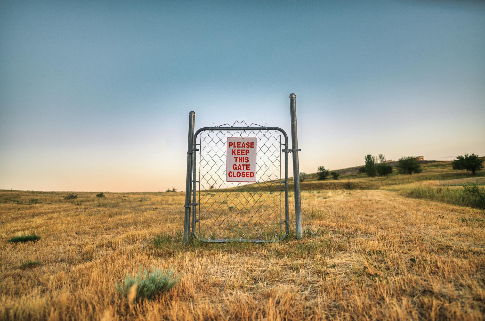 photo of a steel gate standing on a field