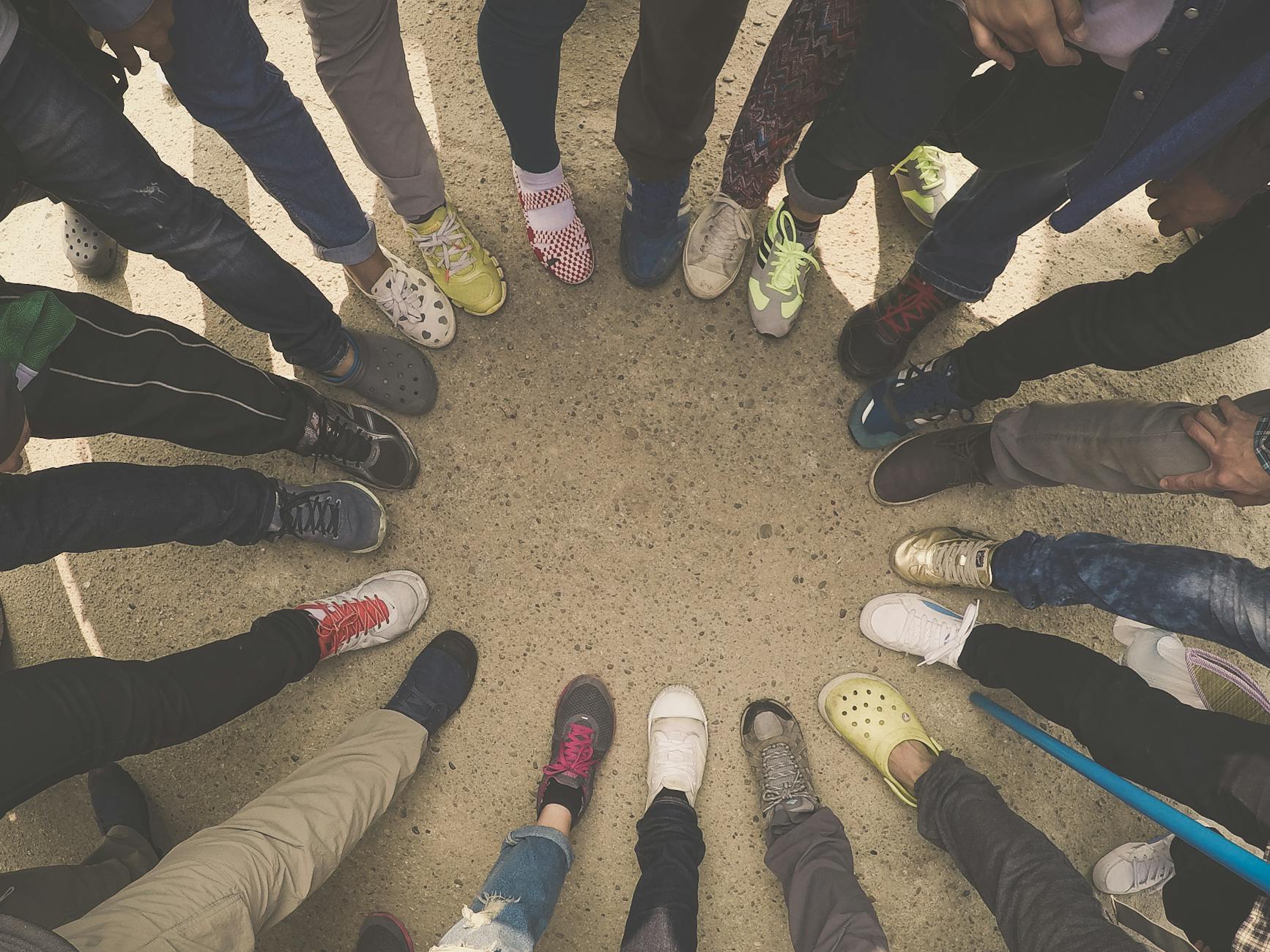 group of people standing on pavement