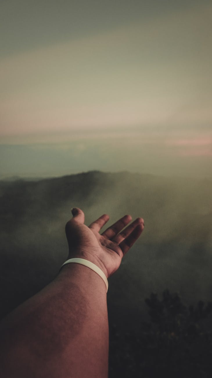 man at the peak of the mountain